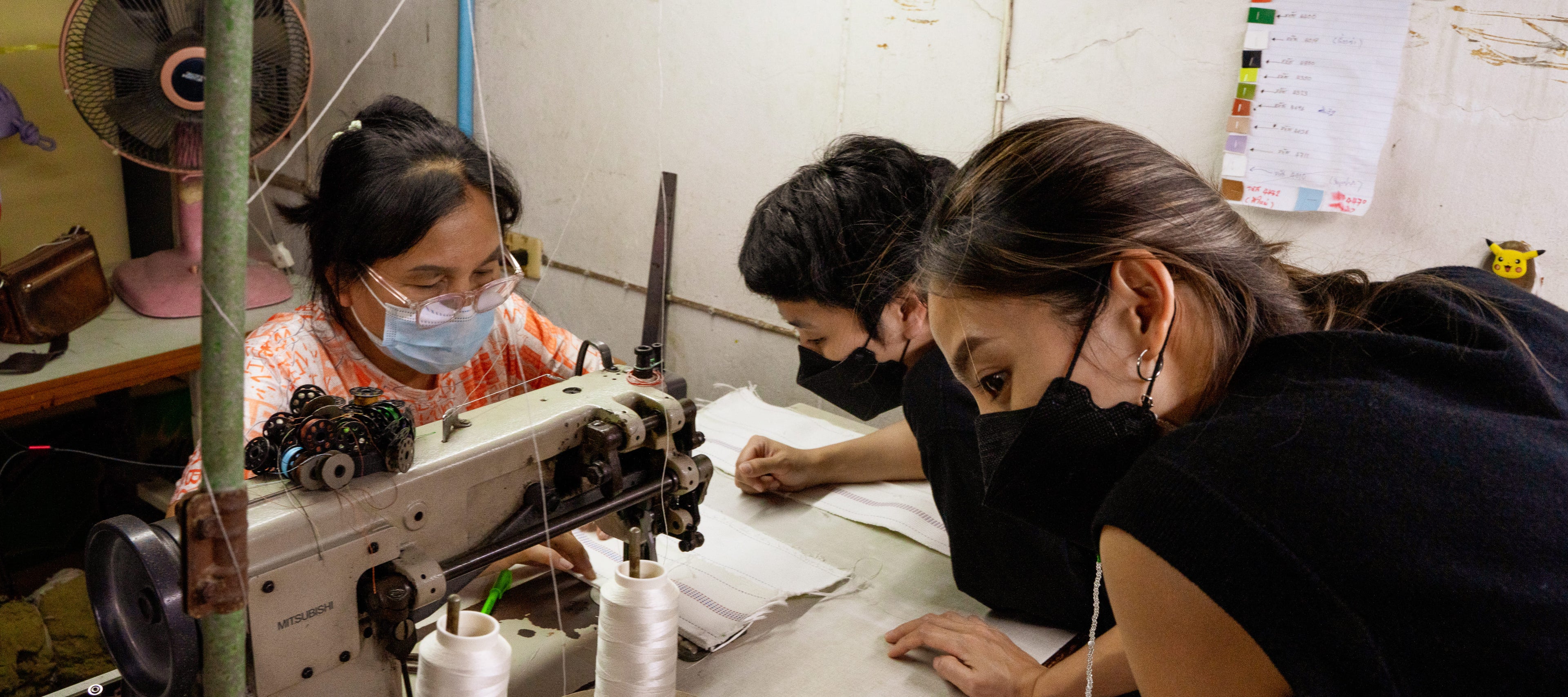 The crafter Chanaphat is overseeing the crafting process of the recycled firehose