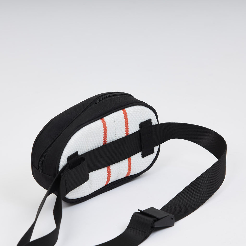 Handmade sustainable and recycled bag from Asia. The cross body bag is made of recycled firehose and sold online on www.qacrafts.com. 