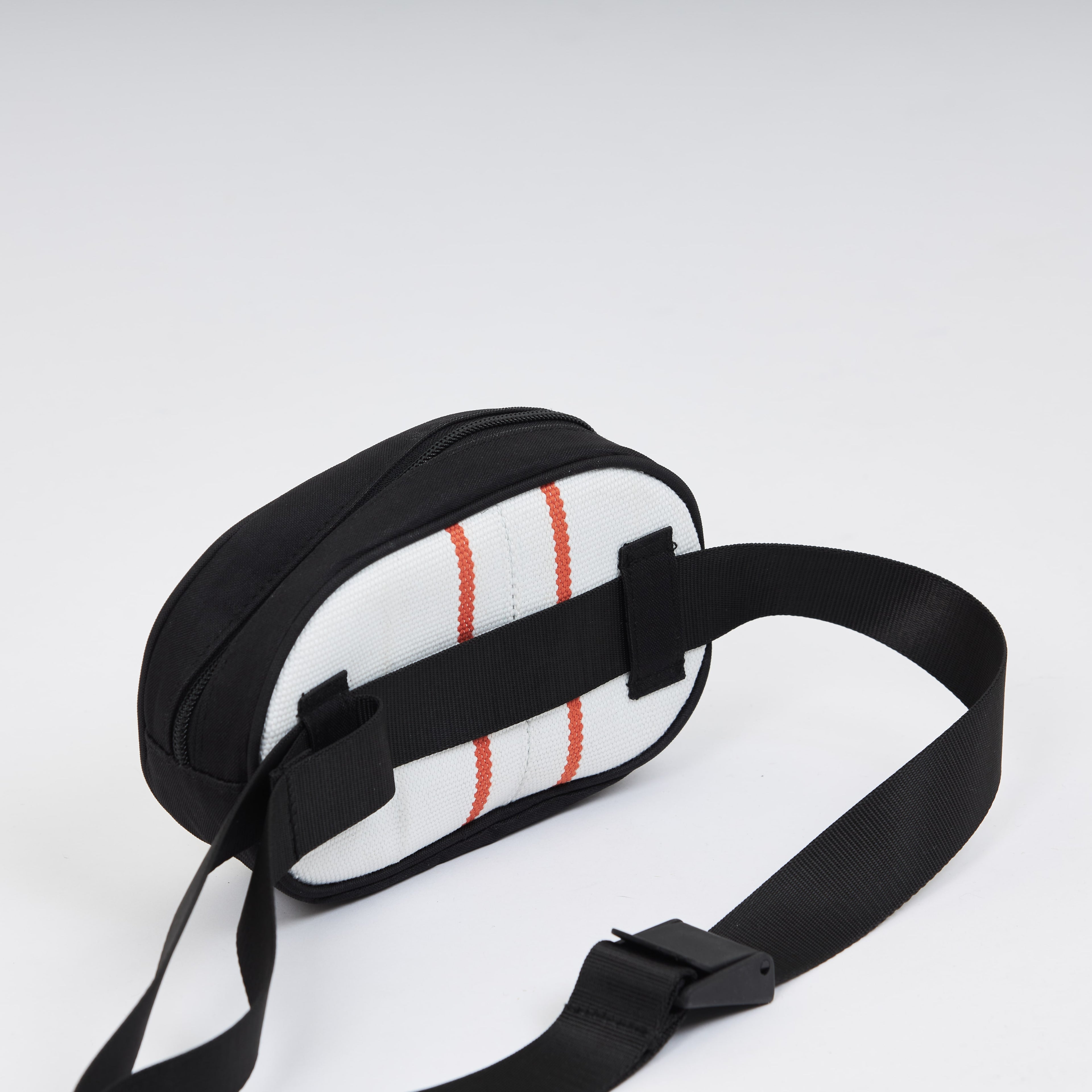 Handmade sustainable and recycled bag from Asia. The cross body bag is made of recycled firehose and sold online on www.qacrafts.com. 
